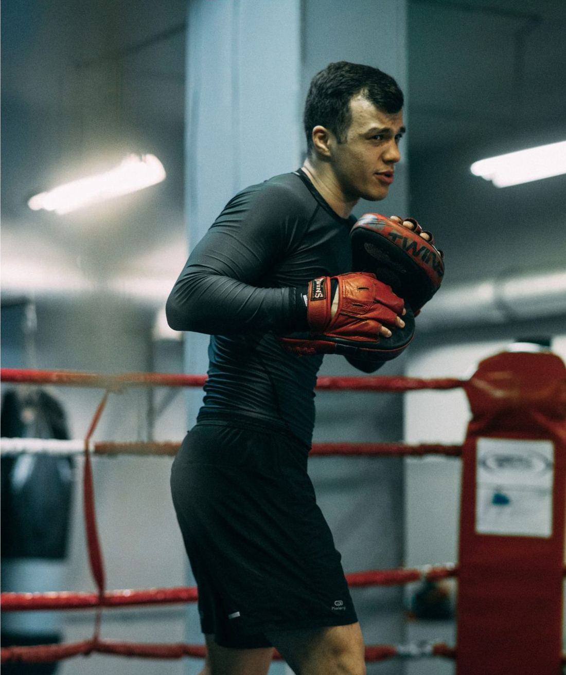 Athlete training with boxing gloves in the ring