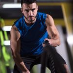 athlete-man-doing-battle-ropes-cross-fitness-exerc-U7JT56D.jpg