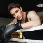 boxer-training-in-a-boxing-ring-looking-aside-PQREL7N.jpg